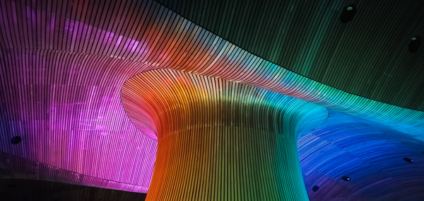 Senedd Funnel lit up in the colours of a rainbow